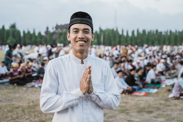 Close up of asian young man smile by gesture apologize