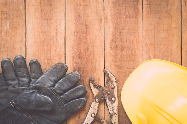 Close up of assorted work tools on wooden background