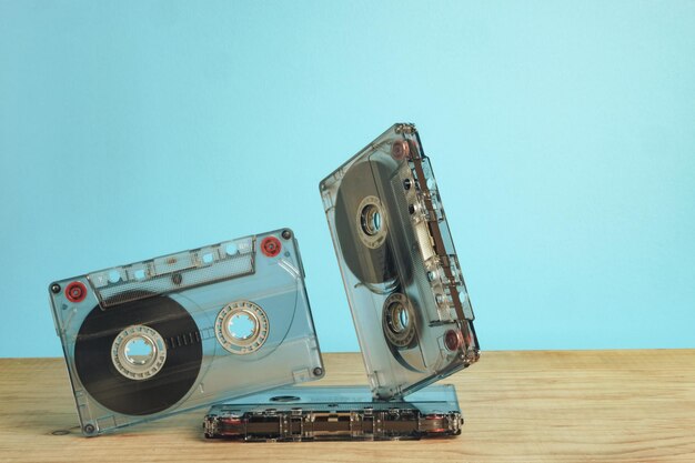 Close up Audio cassette tape on a red wooden table and blue space Minimalism retro style concept 8