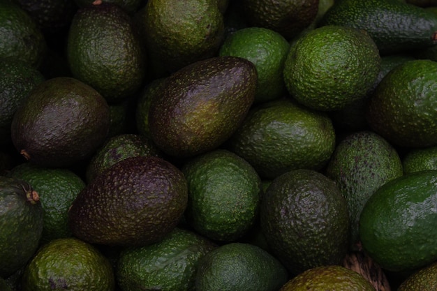 Close-up avocado, exotic tropical fruits, and vegetables