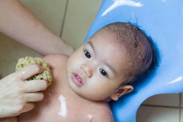 Close up  baby bathing on mothers hands