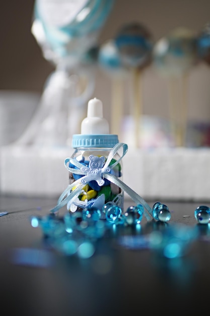 Close-up of baby bottle with decorations on table