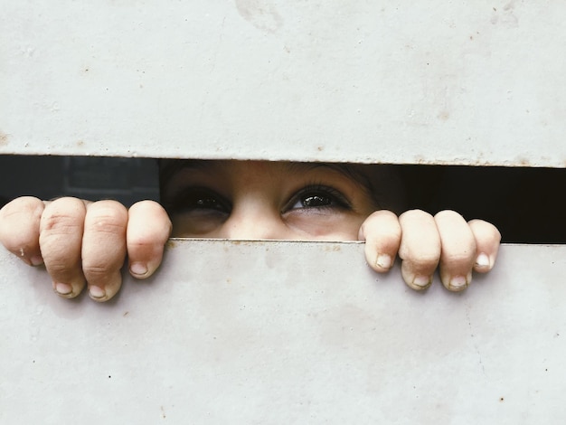 Photo close-up of baby boy peeking