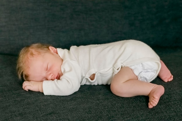 Close-up of baby boy sleeping on bed