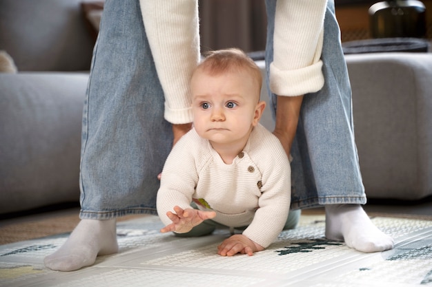 Photo close up on baby crawling and learning to walk