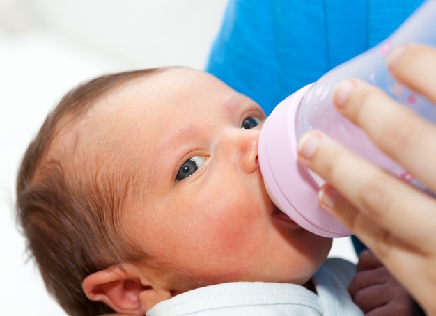 Close up of baby drinking his bottle