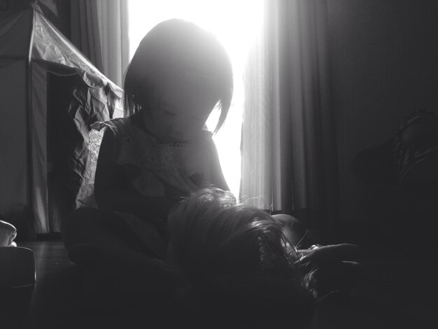 Photo close-up of baby girl playing at home