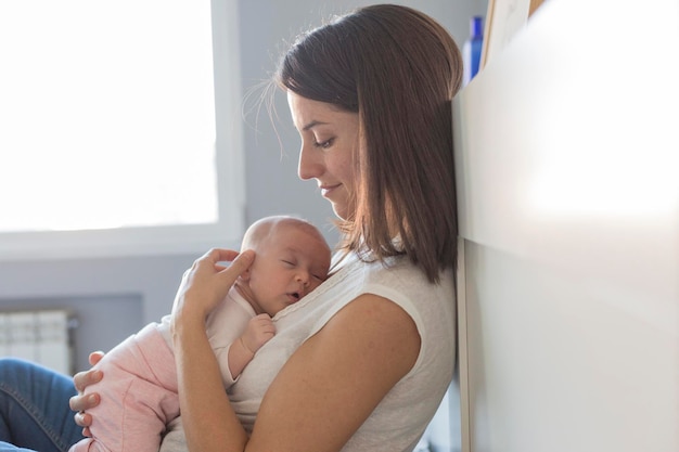 close-up of baby sleeping with mother at home