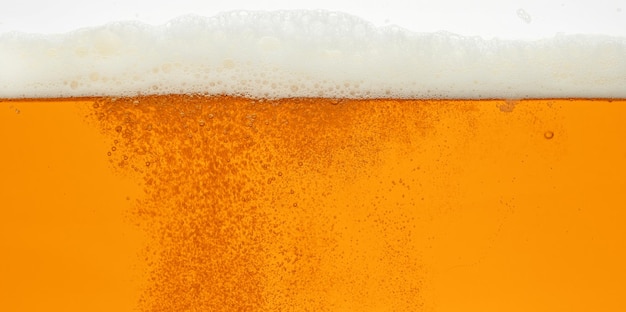 Close up background of beer with bubbles in glass