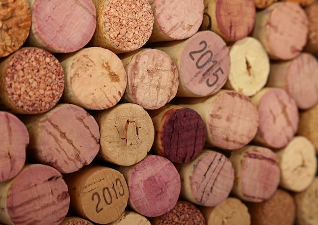 Close up background pattern of many assorted stacked used red wine corks