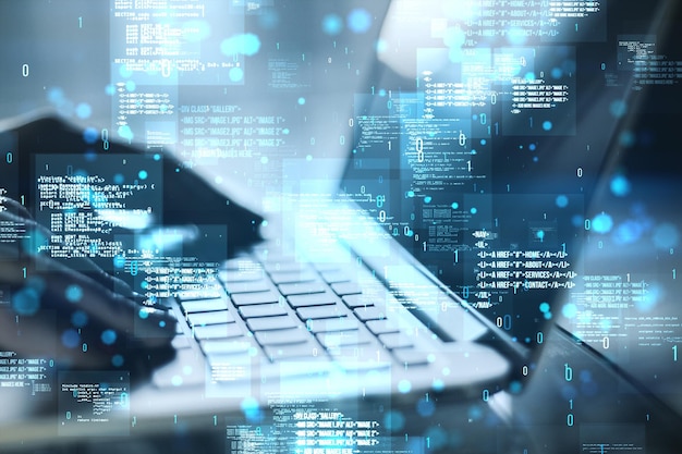 Close up of backlit female hands using laptop with creative binary coding hologram on blurry background Software programming code Double exposure