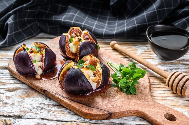 Close-up of baked fig fruits with cottage cheese and honey