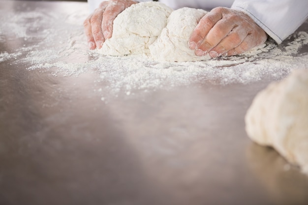  Close up of baker preparing dough