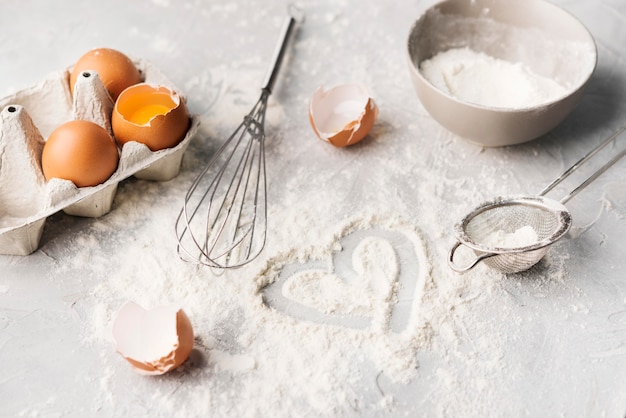 Close-up baking flour on the table with whisk