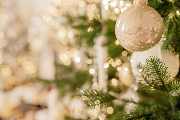 Close up of balls on christmas tree Bokeh garlands in the background New Year concept