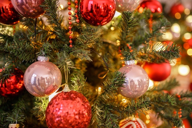 Close up of balls on christmas tree Bokeh garlands in the background New Year concept