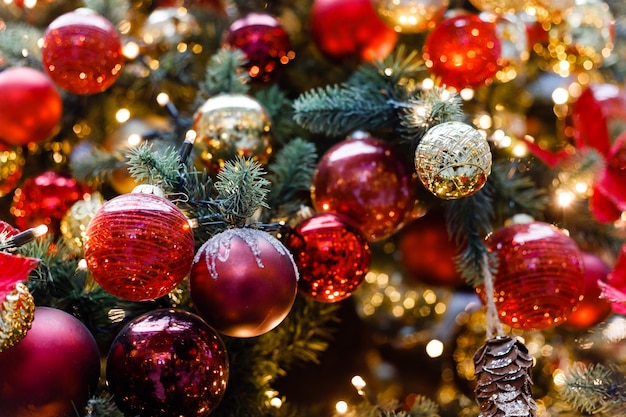 Close up of balls on christmas tree Bokeh garlands in the background New Year concept