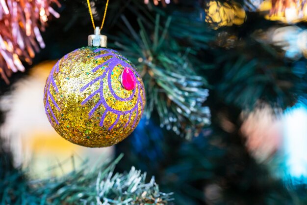 Close up of balls on christmas tree Bokeh garlands in the background