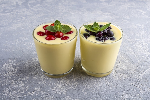 Close-up of banana yogurt and fresh fruits in a glass