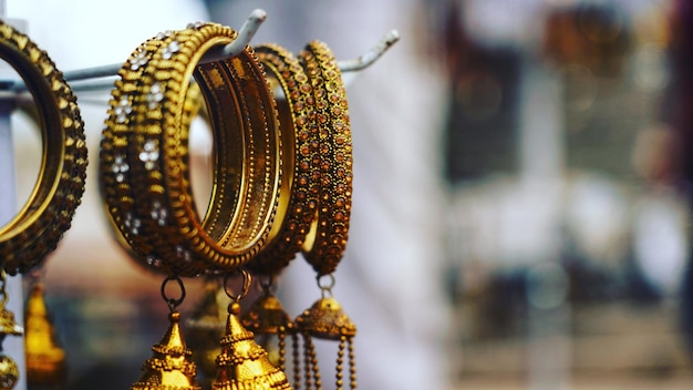 Photo close-up of bangles hanging for sale at store