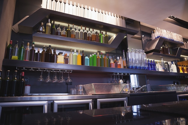 Photo close up on bar with bottle in a line