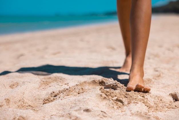 Close up Bare foot woman walking on golden sand beach in Khao Lak Phang Nga Thailand Summer vacation