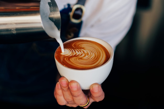 close up barista hand making a cup of coffee.