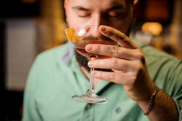 Close up barman with cocktail