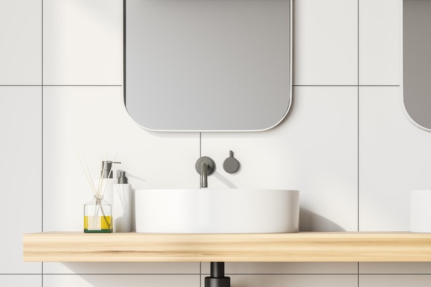 Close up of bathroom sink standing on wooden shelf with mirror above it in room with white tile walls. 3d rendering