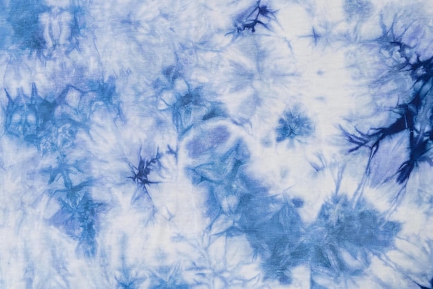 Close-up batik shirt with abstract indigo blue dye detail on white fabric cotton background