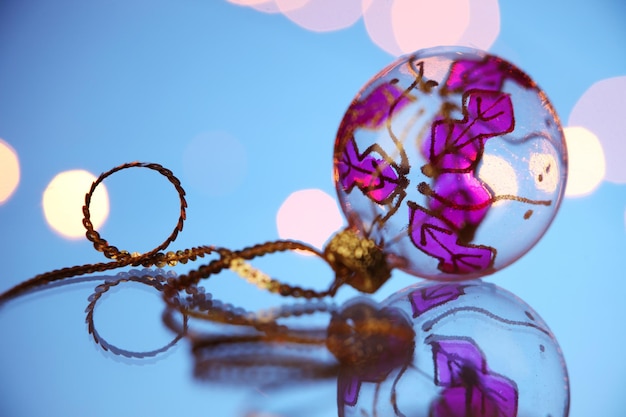 Photo close-up of bauble against defocused lights on table