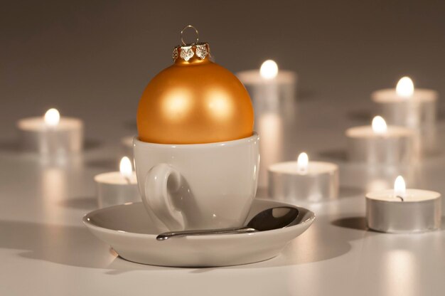 Photo close-up of bauble in cup on white background