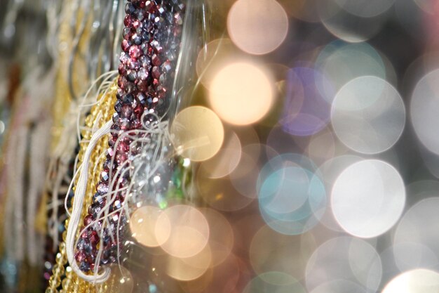 Photo close-up of bead necklaces by defocused lights