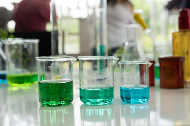 Close-up of beakers with liquid on table