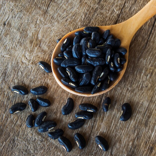 Close up bean seed spoon on wood table