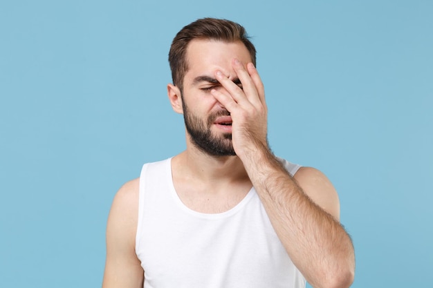 Close up bearded young man 20s years old perfect skin wearing white shirt isolated on blue pastel wall background, studio portrait. Skin care healthcare cosmetic procedures concept. Mock up copy space