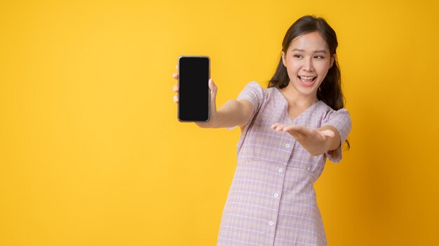 Close up on beautiful Asian woman showing a blank phone screen