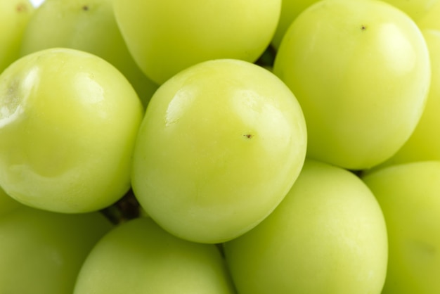 Close up of beautiful a bunch of Shine Muscat green grape isolated on white background, clipping path cut out.