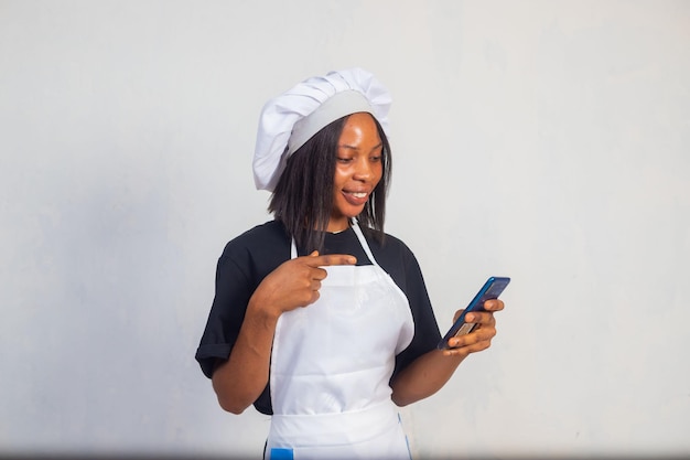 Close up of a beautiful chef using her phone