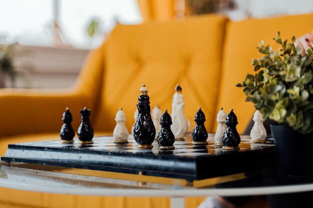 Close up of beautiful chess on table in room Selective focus of porcelain chess pieces on chessboard