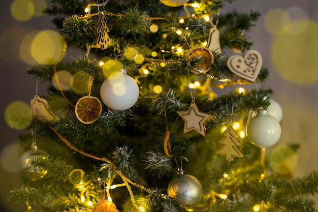 Close up of beautiful decorated Christmas tree with balls and lights