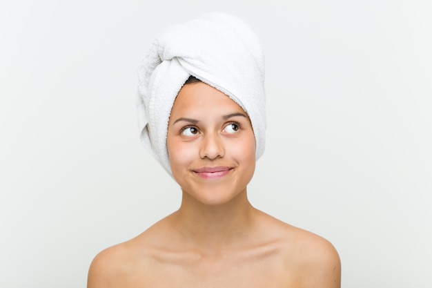 Close up of a beautiful and natural hispanic young woman with a towel on her head