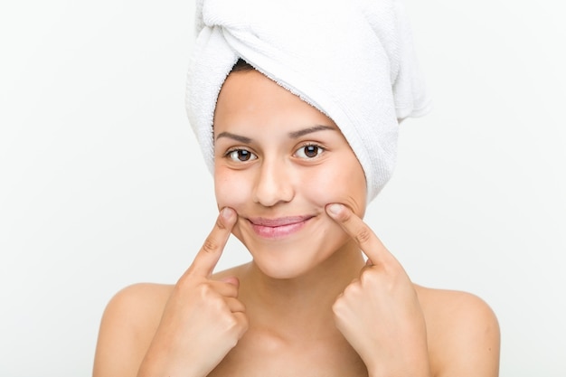 Close up of a beautiful and natural hispanic young woman with a towel on her head