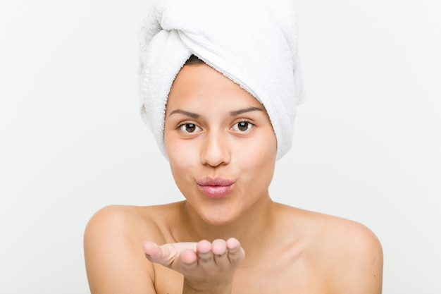 Close up of a beautiful and natural hispanic young woman with a towel on her head