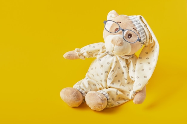 Close up on beautiful teddy bear toy in pijamas