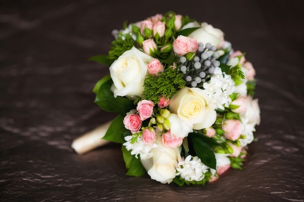 Close up of beautiful wedding bouquet on dark floor