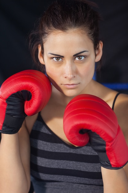 Close-up of a beautiful woman in red boxing gloves