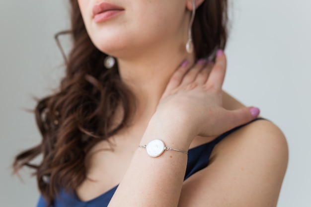 Close-up of beautiful woman wearing bracelet. Accessories, jewelry and bijouterie concept.