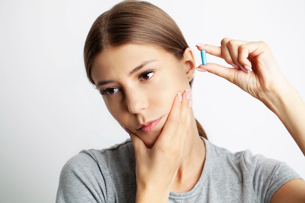 Close up of a beautiful young woman experiencing a painful toothache.