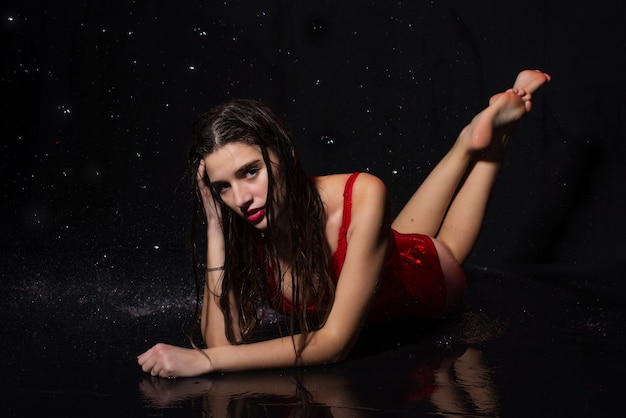 Photo close up on beautiful young woman in red dress